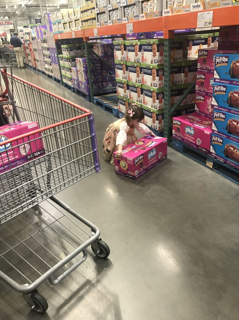 little girl picking up pull ups plus box costco